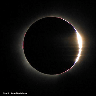 Sunlight peeks through the low points on the moon’s jagged edge during the 2002 total solar eclipse